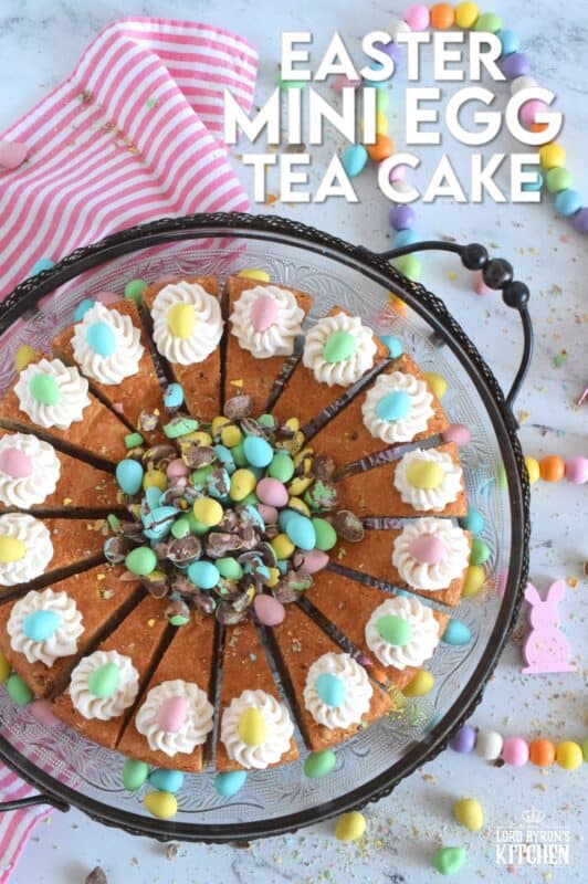 Prepared with crushed chocolate mini eggs and topped with a dollop of buttercream frosting, this Easter Mini Egg Tea Cake looks quite delicious and inviting! Keep the decorating simple with a pile of mini eggs right in the center and let the cake speak for itself! A delightful treat, this cake is a beautiful Easter dessert! #minieggs #easter #cadbury #cake #teacake