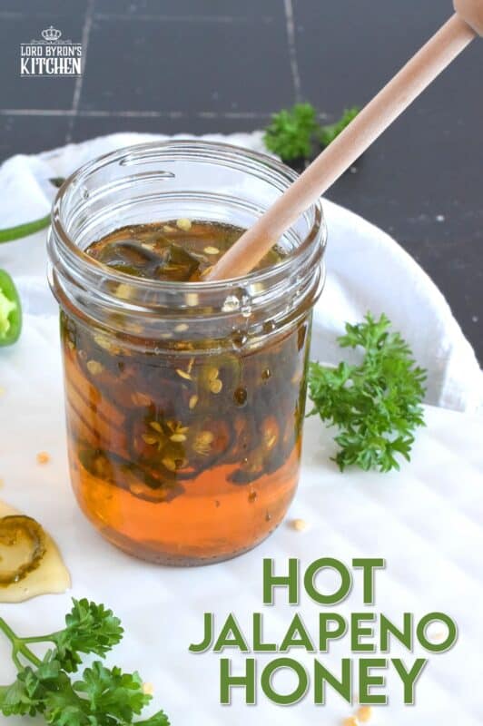 With only two ingredients, this Hot Jalapeno Honey is about to be your new favourite condiment.  Sliced jalapenos are boiled in honey to create a hot and spicy, sticky and sweet drizzling sauce.  Be fair warned, this stuff is so good it's addictive! #jalapeno #honey #hothoney #hotandspicy
