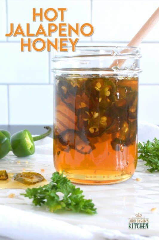 With only two ingredients, this Hot Jalapeno Honey is about to be your new favourite condiment.  Sliced jalapenos are boiled in honey to create a hot and spicy, sticky and sweet drizzling sauce.  Be fair warned, this stuff is so good it's addictive! #jalapeno #honey #hothoney #hotandspicy