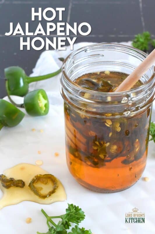 With only two ingredients, this Hot Jalapeno Honey is about to be your new favourite condiment.  Sliced jalapenos are boiled in honey to create a hot and spicy, sticky and sweet drizzling sauce.  Be fair warned, this stuff is so good it's addictive! #jalapeno #honey #hothoney #hotandspicy