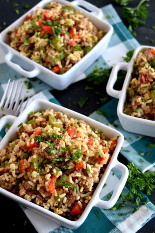 Weeknight dinners can't get any easier than this! Grains, protein, and veggies all together in this One Pot Sausage with Peppers and Rice. This dish has all the bases covered and with very little cleanup as well! Make extra because not only does it freeze well, it reheats quickly and easily too! #onepot #sausage #peppers #rice #familydinners