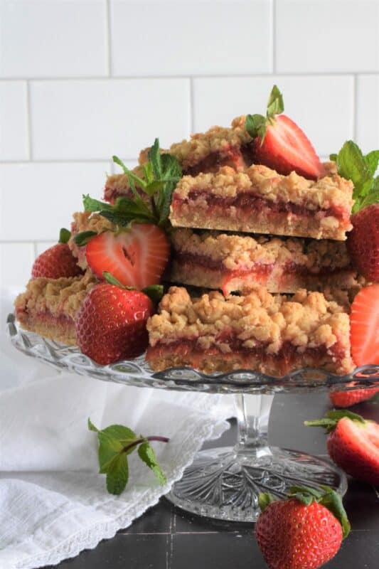Homemade sweet and tart compote is sandwiched between two layers of a buttery and chewy crumb mixture in these Rhubarb Compote Squares. Serve these slightly warmed or at room temperature with fresh berries and a scoop of vanilla ice cream for the ultimate early summer dessert! #rhubarb #cookies #squares #crumb #compote