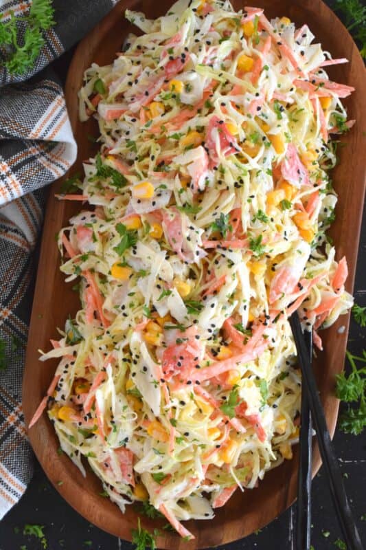 A popular side dish served with sushi, a Japanese Kani Side Salad is so delightfully refreshing, it should not be limited to just a sushi side! Prepared with imitation crab, shredded cabbage, julienned carrots and corn in a creamy and zesty sauce, this salad is wonderfully easy and exceptionally delicious! #kani #salad #japanese #crab