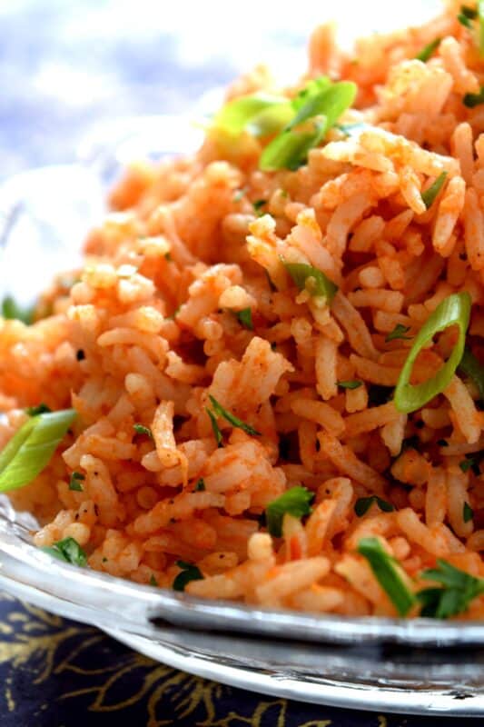 A fast and delicious side dish using leftover rice! Tomato and Garlic Fried Rice is prepared with a hint of fresh lime, and the rustic flavours of onions, garlic, and tomatoes, this dish is sure to bring much needed life to any plate! #friedrice #rice #garlicky #leftover #sidedish