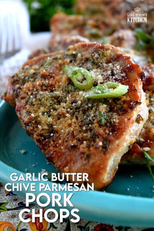 Using thin, boneless pork chops to keep the baking time quick, these chops are prepared with fresh garlic, salted butter, chopped chives, and freshly grated parmesan cheese. They are so simple, yet deliciously impressive! #porkchops #garlic #parmesan #fastfry