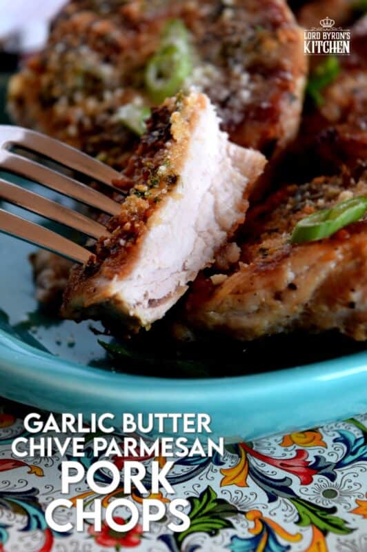 Using thin, boneless pork chops to keep the baking time quick, these chops are prepared with fresh garlic, salted butter, chopped chives, and freshly grated parmesan cheese. They are so simple, yet deliciously impressive! #porkchops #garlic #parmesan #fastfry