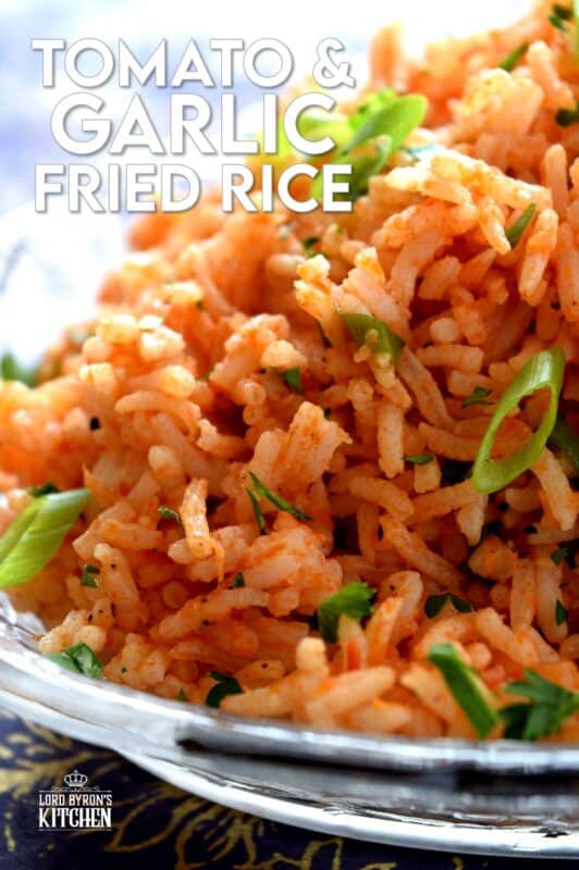 A fast and delicious side dish using leftover rice! Tomato and Garlic Fried Rice is prepared with a hint of fresh lime, and the rustic flavours of onions, garlic, and tomatoes, this dish is sure to bring much needed life to any plate! #friedrice #rice #garlicky #leftover #sidedish