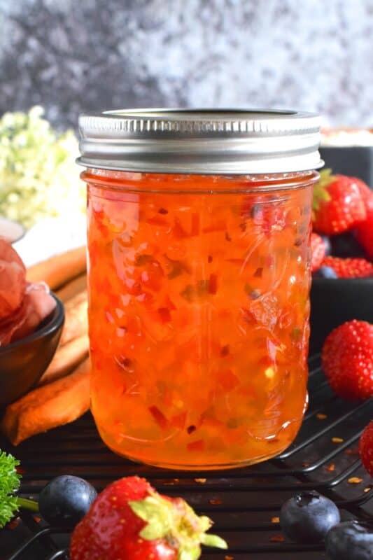 Possibly considered to be more of an appetizer or a dip, Hot Sweet Pepper Jelly is easy to prepare and makes for a quick and easy appetizer or ingredient. These are canned using the water bath canning method, which couldn't be easier! This post will walk you through every step. #hotpepperjelly #hotandsweet #sweetpeppers #canning #preserves #jelly #cannedjelly