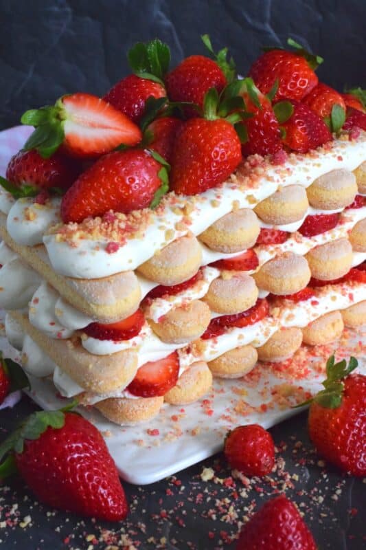 Locally grown strawberries are about to be in season which means it is time for a little indulgence! Strawberry Shortcake Tiramisu is the most delicious summertime dessert. With layers of homemade strawberry shortcake crumbs, light and airy ladyfingers, and a thick, slightly sweet filling, this dessert is completely irresistible! #strawberry #shortcake #tiramisu