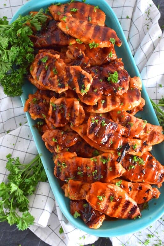 Grilled Catalina Chicken is made by marinating sliced chicken breasts in Catalina Salad Dressing with some additional seasonings. Next, the chicken is grilled to perfection. They're moist, saucy, tangy, and a little bit sweet. #catalina #saladdressing #grilling #grilledchicken #chicken