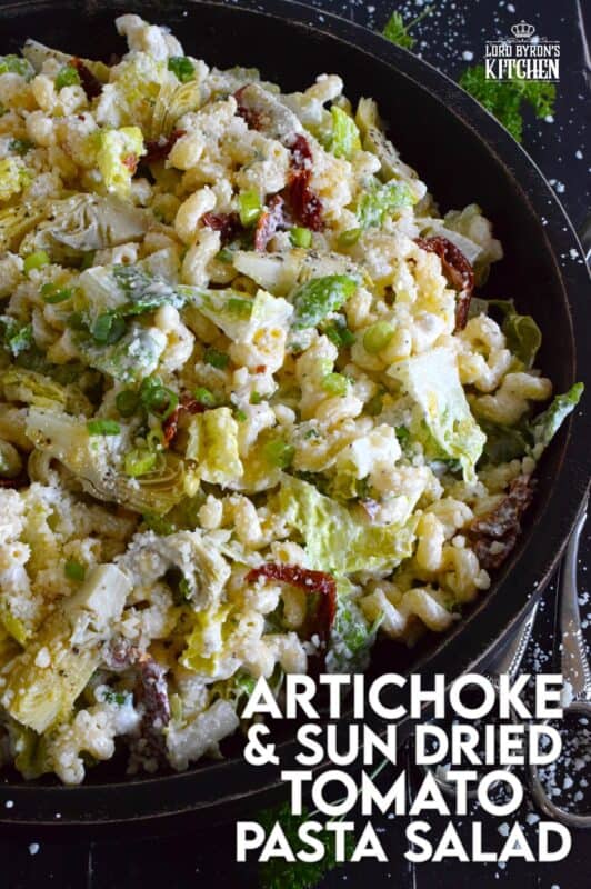 Prepared with pasta, lettuce, canned artichokes, chopped sun-dried tomatoes, onions, and parmesan, this salad can be a delicious side or a complete meal! The hot and hazy days of summer are just weeks away, so save this recipe now for your backyard barbecues and those family picnics! #sundried #tomato #pasta #salad #artichoke