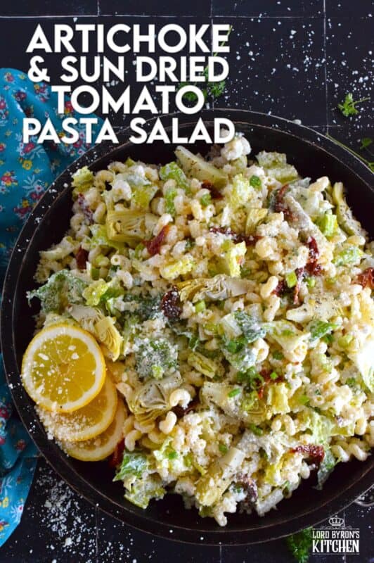 Prepared with pasta, lettuce, canned artichokes, chopped sun-dried tomatoes, onions, and parmesan, this salad can be a delicious side or a complete meal! The hot and hazy days of summer are just weeks away, so save this recipe now for your backyard barbecues and those family picnics! #sundried #tomato #pasta #salad #artichoke