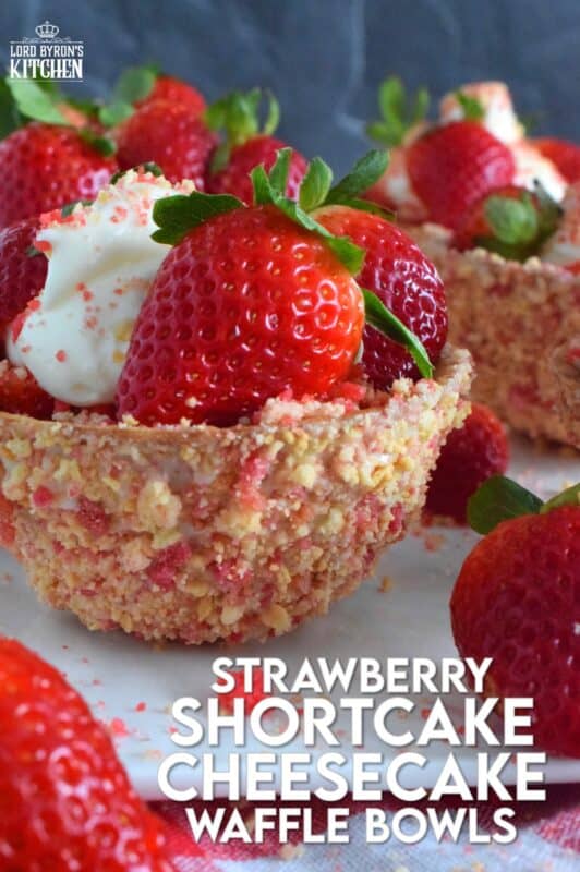 Sugary sweet and crunchy waffle bowls are coated with strawberry shortcake crumbs and filled with a light and fluffy cheesecake mixture, topped with fresh strawberries, and more strawberry shortcake crumbs. This gorgeously impressive dessert is for the serious strawberry lover! #shortcake #waffle #strawberry #cheesecake