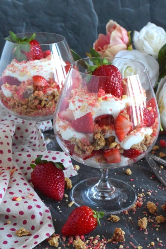 This beautifully presented dessert is exceptionally easy to prepare. Layered with granola, yogurt, and fresh strawberries, is a homemade strawberry shortcake crumb mixture that is the star of this simply refreshing summertime dessert. It's a healthy alternative with just the right amount of indulgence! #strawberries #shortcake #parfait #crumbs