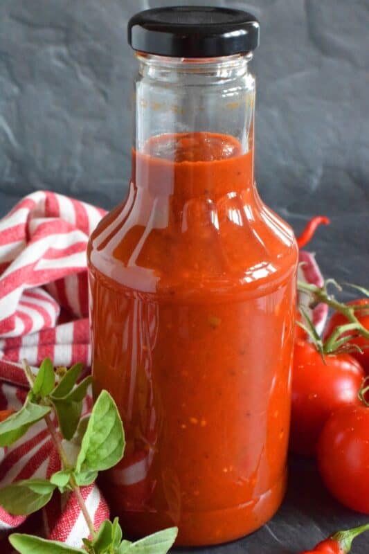 This tomato-based BBQ sauce has so much flavour! It is prepared with tomatoes, onions, bell peppers, garlic, and a hot chili or two if you like it spicy. Process in a water bath canner and stock your pantry with what is about to become your new favourite condiment! #bbq #sauce #canning #tomatoes