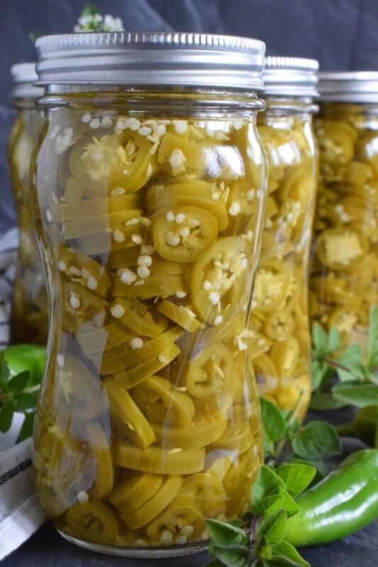 Pair these Canned Pickled Jalapenos with sandwiches, pizza, nachos, burgers, and even scrambled eggs! All you need to prepare these are jalapenos, white vinegar, salt, and water! Easily double or even triple the recipe and stock your canning pantry with these delicious hot and spicy morsels! #pickled #jalapenos