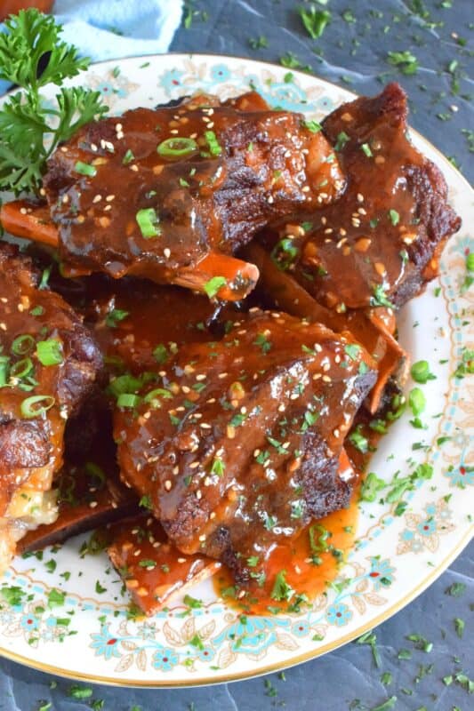 Instant Pot Korean Beef Ribs are fall-off-the-bone tender! This super quick and easy recipe packs a punch of robust and savoury flavours. Prepared with gochujang and honey, these ribs are both a little spicy and sweet. As an added bonus, the cooking liquid doubles as a thick, delicious sauce! #korean #shortribs #beef #ribs #instantpot