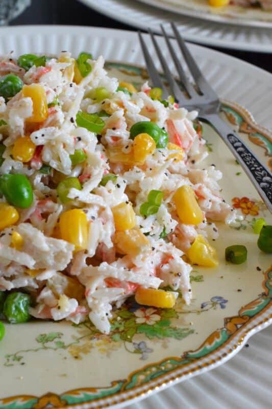 Prepare this recipe using real or imitation crab and leftover cooked rice. Great as a side, but hearty and filling enough to be served as a main, Creamy Crab and Rice Salad tastes light and fresh and is simply delicious! #crab #salad #rice #imitation #seafood