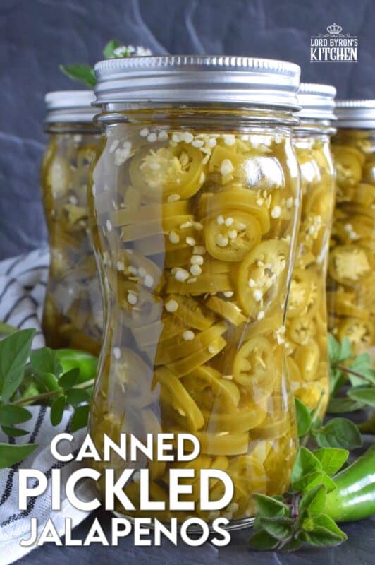 Pair these Canned Pickled Jalapenos with sandwiches, pizza, nachos, burgers, and even scrambled eggs! All you need to prepare these are jalapenos, white vinegar, salt, and water! Easily double or even triple the recipe and stock your canning pantry with these delicious hot and spicy morsels! #pickled #jalapenos
