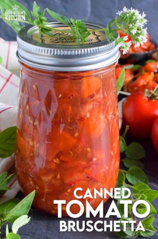 Summer fresh tomatoes are packed into jars and canned with fresh garlic and red onions. Well-seasoned and preserved Canned Tomato Bruschetta can be easily and quickly assembled at any time! Pile onto grilled bread or toss with cooked pasta for a delicious meal! This is a great way to preserve your homegrown tomatoes! #bruschetta #canned #tomatoes #preserved