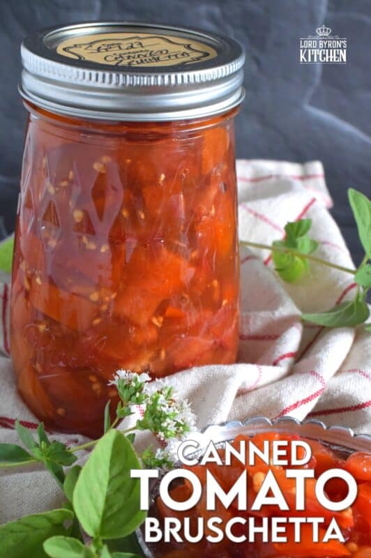 Summer fresh tomatoes are packed into jars and canned with fresh garlic and red onions. Well-seasoned and preserved Canned Tomato Bruschetta can be easily and quickly assembled at any time! Pile onto grilled bread or toss with cooked pasta for a delicious meal! This is a great way to preserve your homegrown tomatoes! #bruschetta #canned #tomatoes #preserved