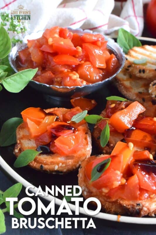 Summer fresh tomatoes are packed into jars and canned with fresh garlic and red onions. Well-seasoned and preserved Canned Tomato Bruschetta can be easily and quickly assembled at any time! Pile onto grilled bread or toss with cooked pasta for a delicious meal! This is a great way to preserve your homegrown tomatoes! #bruschetta #canned #tomatoes #preserved