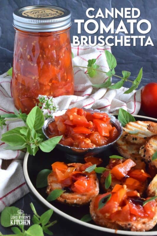 Summer fresh tomatoes are packed into jars and canned with fresh garlic and red onions. Well-seasoned and preserved Canned Tomato Bruschetta can be easily and quickly assembled at any time! Pile onto grilled bread or toss with cooked pasta for a delicious meal! This is a great way to preserve your homegrown tomatoes! #bruschetta #canned #tomatoes #preserved