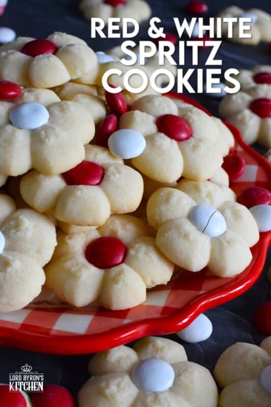 This recipe combines two very popular types of cookies – a spritz cookie and a thumbprint cookie! The base is slightly sweet and buttery and is perfectly paired with a single candy-coated chocolate. These are slightly crumbly, but not dry, and paired with a red or white M&M candy, these cookies are delicious! #redandwhite #canadaday #cookies #spritz