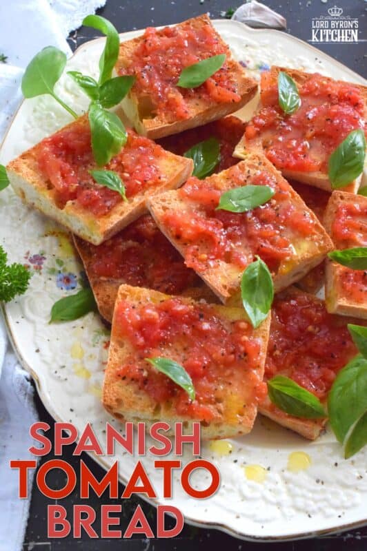 Summer fresh tomatoes are peeled and mashed and spread onto warm, toasted bread that has been rubbed with whole garlic cloves. Seasoned with ground black pepper and flaked sea salt, and a splash of olive oil, Spanish Tomato Bread is a popular tapas bar recipe! #catalan #spanish #tomato #bread