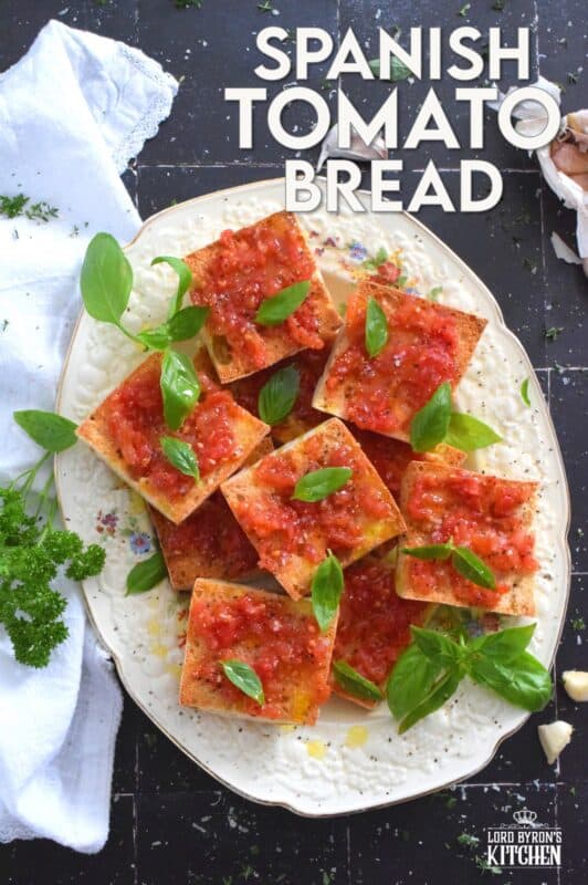 Summer fresh tomatoes are peeled and mashed and spread onto warm, toasted bread that has been rubbed with whole garlic cloves. Seasoned with ground black pepper and flaked sea salt, and a splash of olive oil, Spanish Tomato Bread is a popular tapas bar recipe! #catalan #spanish #tomato #bread