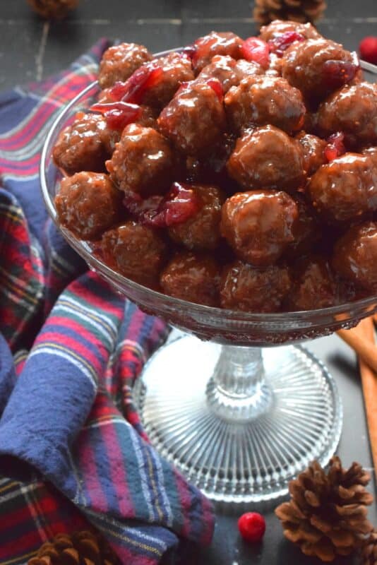 Serve these Crab Apple Cranberry Meatballs as a holiday appetizer and watch just how quickly they disappear! Store-bought frozen meatballs are paired with frozen cranberries, apple juice, and a jar of jelly to make a very delicious and festive party favourite! #crabapple #meatballs #holiday #appetizers