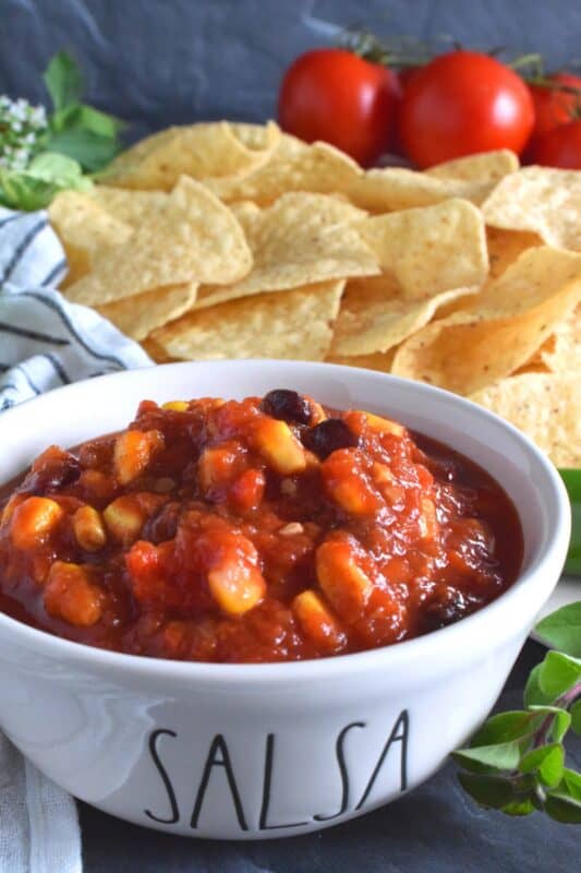Corn and Black Bean Salsa not only includes all of your favourite salsa ingredients like tomatoes, peppers, and onions, but also has jalapenos, canned corn, and canned black beans too. Using a water bath canning method, it's easy to stock your pantry with this bright and fresh salsa recipe! #corn #blackbean #salsa #homemade #canned