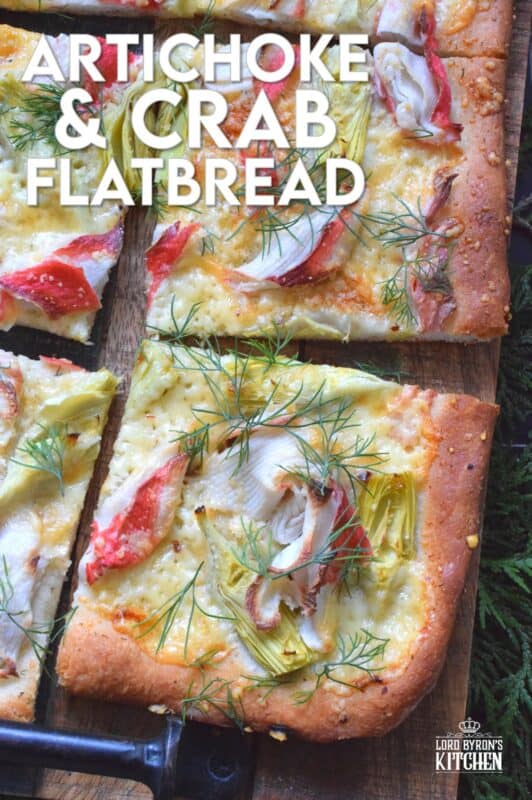 Cheesy, garlicky, and spicy are three words one could use to describe this Artichoke and Crab Flatbread.  Easy to prepare, but authentically delicious, this appetizer will be talked about long after the holidays are over, which is why this recipe makes two! #appetizer #seafood #crab #holiday #christmas #flatbread