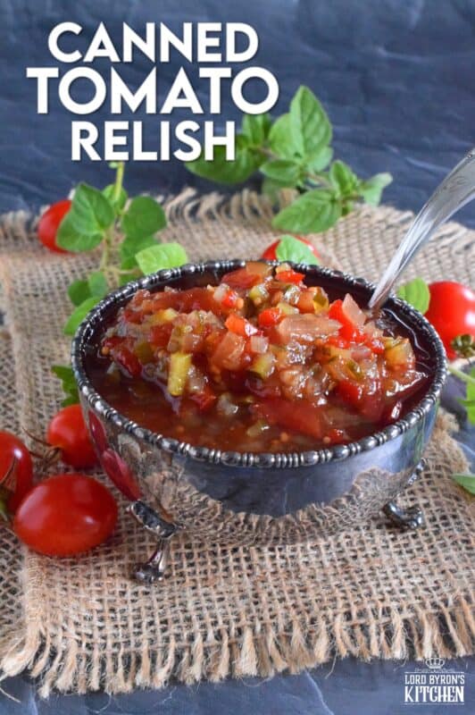 Spoon this Canned Tomato Relish onto hamburgers, hotdogs, sausages, and sandwiches too. Prepared with cucumbers, bell peppers, zucchini, onion, and tomatoes, this relish is the best way to preserve all of that homegrown late-summer harvest! #hamburger #tomato #relish #canning #preserves #tomatoes