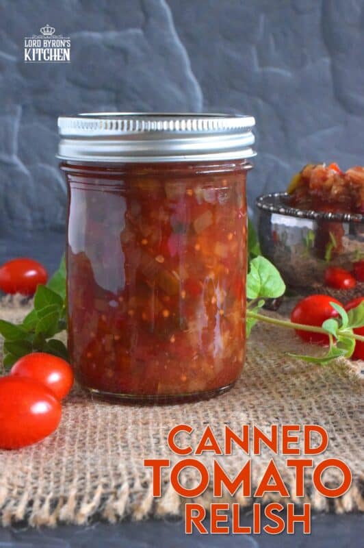 Spoon this Canned Tomato Relish onto hamburgers, hotdogs, sausages, and sandwiches too. Prepared with cucumbers, bell peppers, zucchini, onion, and tomatoes, this relish is the best way to preserve all of that homegrown late-summer harvest! #hamburger #tomato #relish #canning #preserves #tomatoes