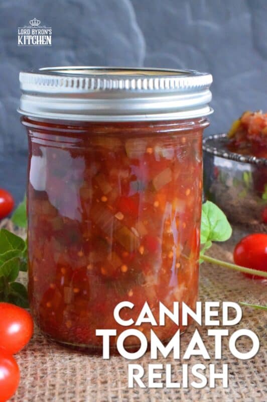 Spoon this Canned Tomato Relish onto hamburgers, hotdogs, sausages, and sandwiches too. Prepared with cucumbers, bell peppers, zucchini, onion, and tomatoes, this relish is the best way to preserve all of that homegrown late-summer harvest! #hamburger #tomato #relish #canning #preserves #tomatoes
