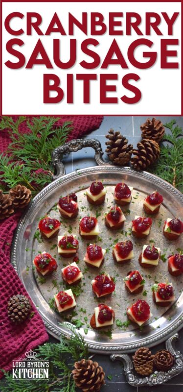 Oven-roasted smoked sausage is topped with a slice of aged cheddar cheese and dressed with cranberries. The big-bite combination of salty sausage, and creamy cheese, with sweet and bitter cranberries, is delightful! #cranberry #sausage #appetizer #holiday #christmas