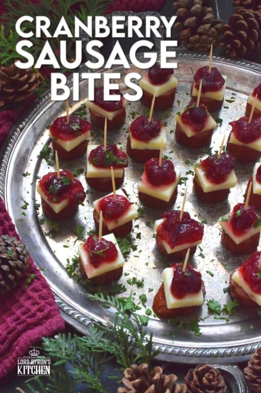 Oven-roasted smoked sausage is topped with a slice of aged cheddar cheese and dressed with cranberries. The big-bite combination of salty sausage, and creamy cheese, with sweet and bitter cranberries, is delightful! #cranberry #sausage #appetizer #holiday #christmas