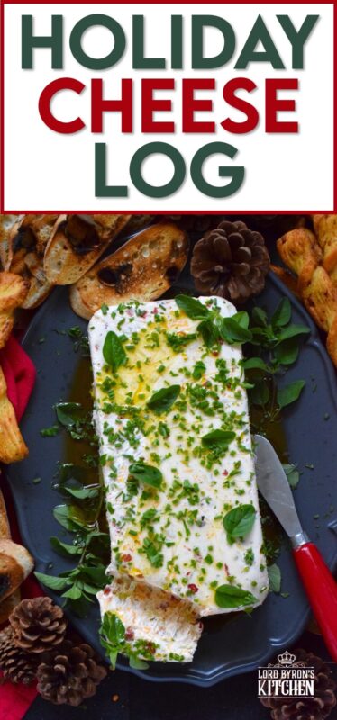 This Holiday Cheese Log is packed with a tonne of flavourful add-ins, such as chili flakes, roasted red peppers, sun-dried tomatoes, and fresh chives. Seasoned with garlic, onion, basil, oregano, and more, this holiday appetizer is a tremendously delicious party favourite! #cheeselog #appetizer #holiday #christmas