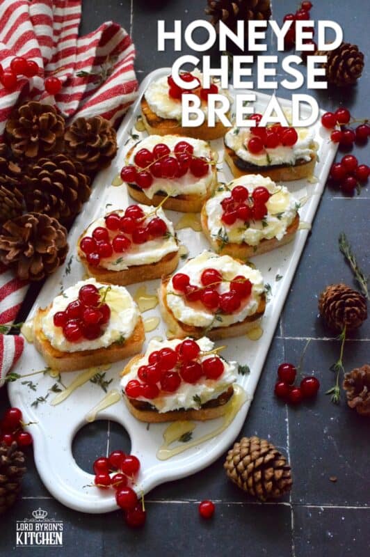 Toast or grill thinly sliced bread and top it with whipped goat cheese. Drizzle over your favourite honey and garnish with fresh thyme leaves and berries. Honeyed Cheese Bread is sweet and salty and is completely irresistible. The creaminess of the cheese and honey is a great match for the chewiness of the toasted baguette. #honey #bread #appetizer #christmas #holiday