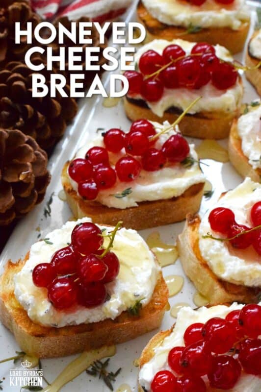 Toast or grill thinly sliced bread and top it with whipped goat cheese. Drizzle over your favourite honey and garnish with fresh thyme leaves and berries. Honeyed Cheese Bread is sweet and salty and is completely irresistible. The creaminess of the cheese and honey is a great match for the chewiness of the toasted baguette. #honey #bread #appetizer #christmas #holiday