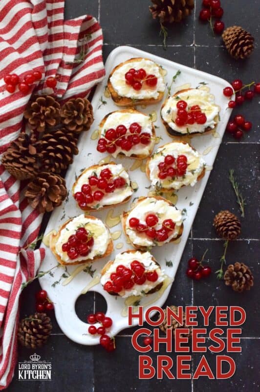 Toast or grill thinly sliced bread and top it with whipped goat cheese. Drizzle over your favourite honey and garnish with fresh thyme leaves and berries. Honeyed Cheese Bread is sweet and salty and is completely irresistible. The creaminess of the cheese and honey is a great match for the chewiness of the toasted baguette. #honey #bread #appetizer #christmas #holiday