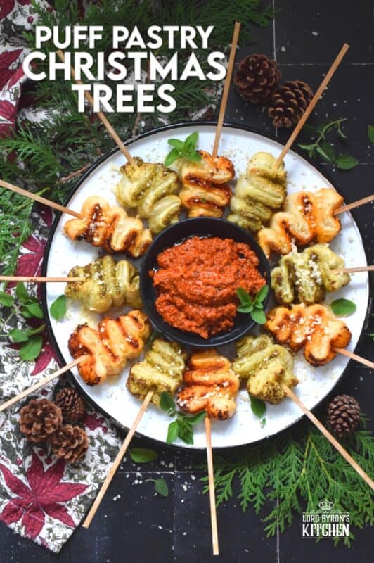 This light and airy appetizer is prepared with store-bought sheets of frozen puff pastry and your favourite sun-dried tomato or basil pesto.  They're so quick and easy to prepare - anyone can do this!  Serve with a side of warm marinara sauce for best results. #holilday #christmas #appetizer #puffpastry #pesto