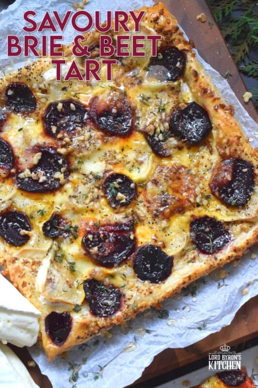 The combination of roasted beets, walnuts, and cheese is unbeatable! This Savoury Brie and Beet Tart has all three of those ingredients baked on a light and fluffy puff pastry, drizzled with honey, and topped with fresh herbs. It's hard to eat just one slice! #beets #brie #cheese #tart #appetizer #holiday