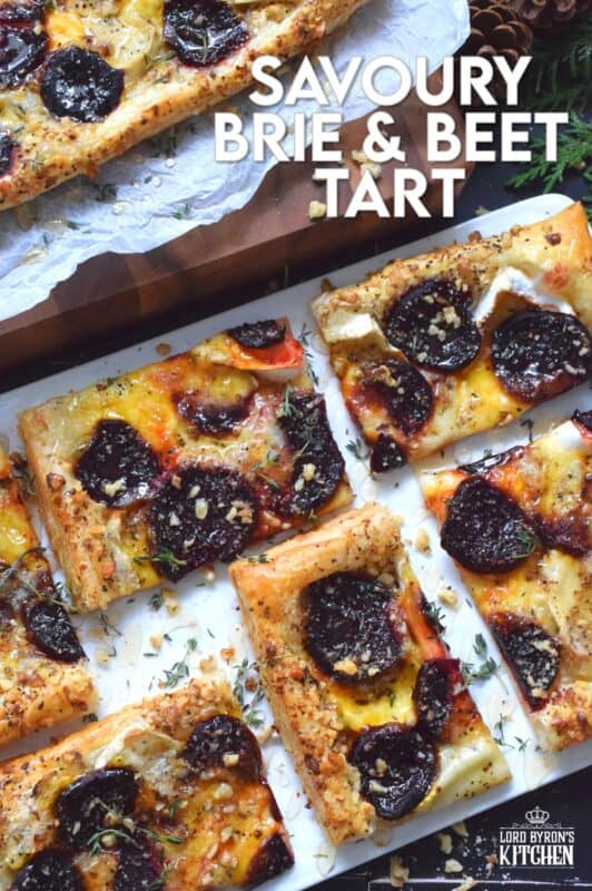 The combination of roasted beets, walnuts, and cheese is unbeatable! This Savoury Brie and Beet Tart has all three of those ingredients baked on a light and fluffy puff pastry, drizzled with honey, and topped with fresh herbs. It's hard to eat just one slice! #beets #brie #cheese #tart #appetizer #holiday