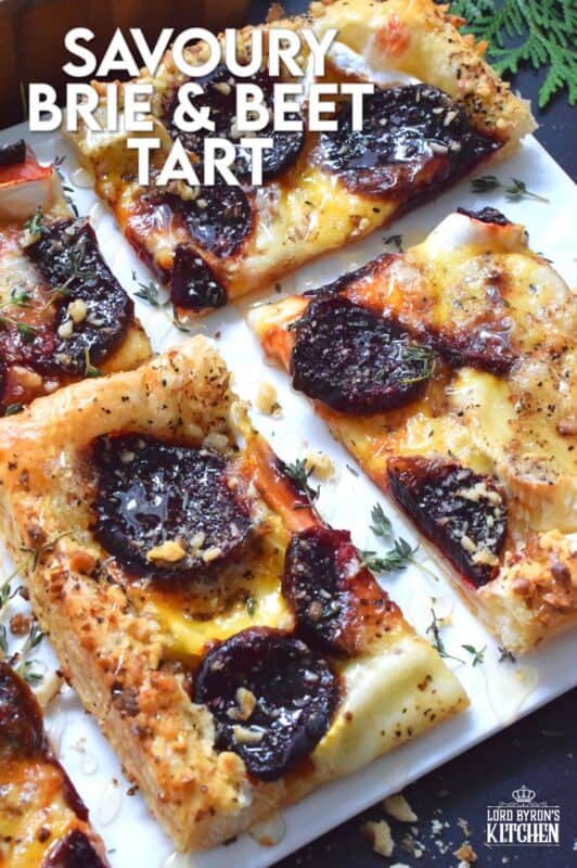 The combination of roasted beets, walnuts, and cheese is unbeatable! This Savoury Brie and Beet Tart has all three of those ingredients baked on a light and fluffy puff pastry, drizzled with honey, and topped with fresh herbs. It's hard to eat just one slice! #beets #brie #cheese #tart #appetizer #holiday
