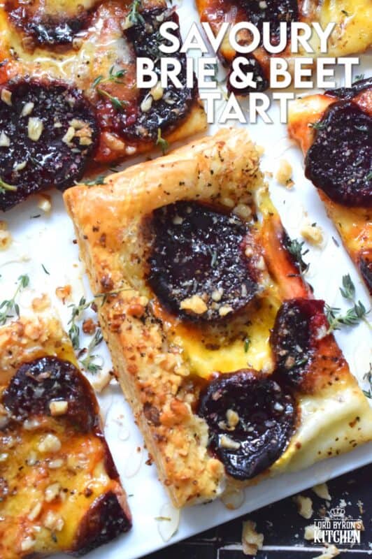 The combination of roasted beets, walnuts, and cheese is unbeatable! This Savoury Brie and Beet Tart has all three of those ingredients baked on a light and fluffy puff pastry, drizzled with honey, and topped with fresh herbs. It's hard to eat just one slice! #beets #brie #cheese #tart #appetizer #holiday