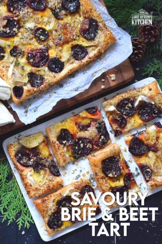 The combination of roasted beets, walnuts, and cheese is unbeatable! This Savoury Brie and Beet Tart has all three of those ingredients baked on a light and fluffy puff pastry, drizzled with honey, and topped with fresh herbs. It's hard to eat just one slice! #beets #brie #cheese #tart #appetizer #holiday