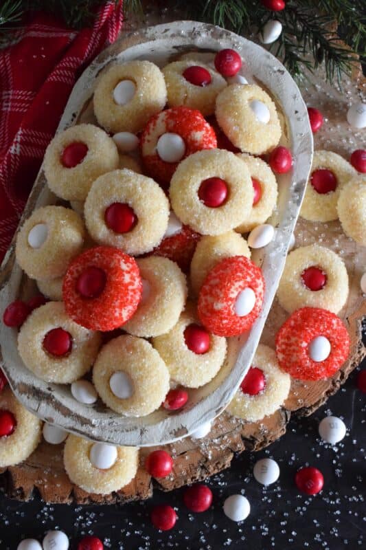 These are miniature, one-bite cookies that are made with Christmas M&M candy centers. Santa's Suit Buttons are a wonderful gift idea, a great baking project with the kids, or bake them alone and save them all for yourself! #santassuit #buttons #cookies #christmas #holiday #baking #kids