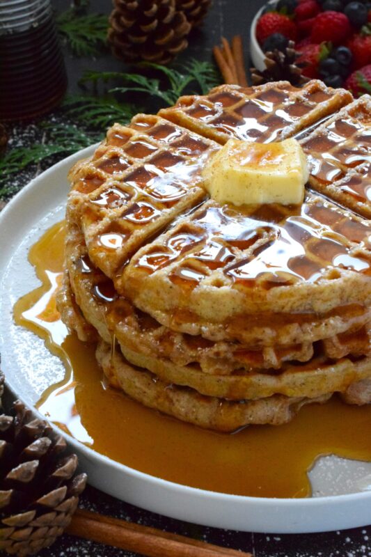 If Christmas had a flavour, it would be gingerbread, so let's start the day off right with these light and airy Buttermilk Gingerbread Waffles! These super easy-to-prepare homemade waffles are piled high and generously dressed with warm syrup and a pat of butter. #waffles #gingerbread #christmas #breakfast